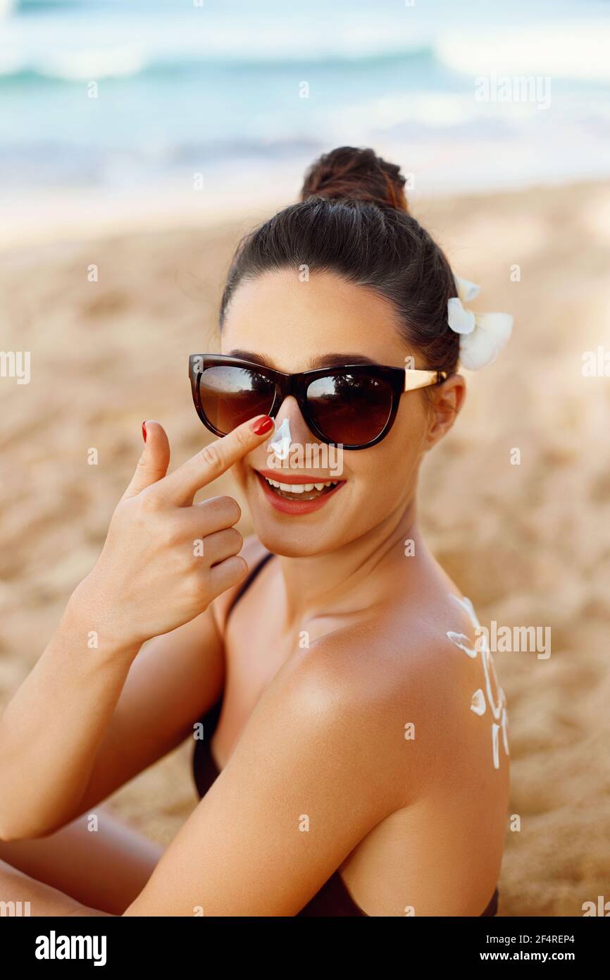 Suntan Lotion Woman Applying Sunscreen Solar Cream. Suncream.The Girl