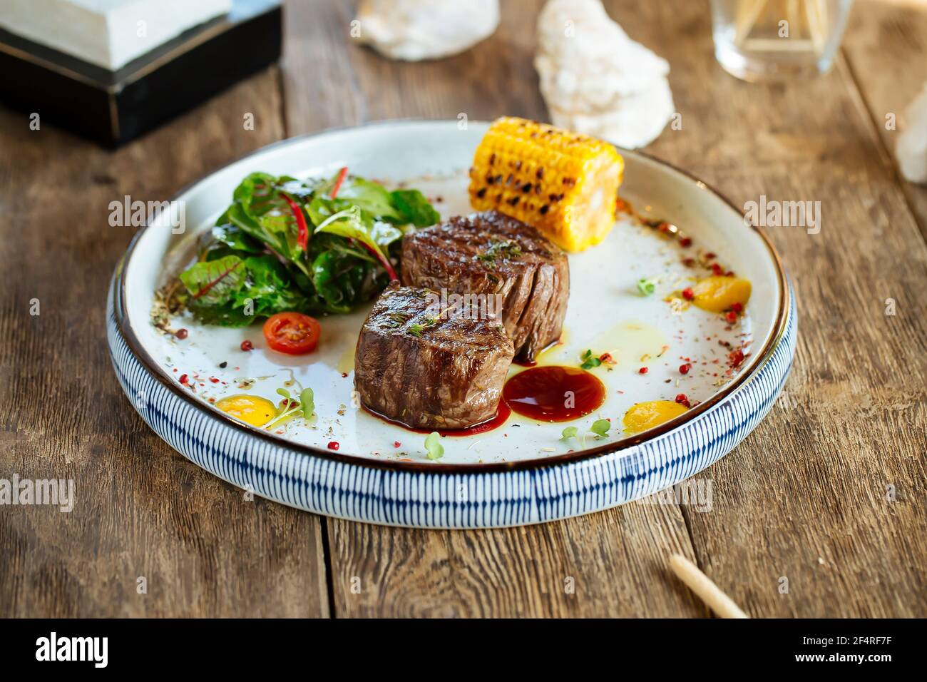 Grilled fillet mignon steaks with corn and salad Stock Photo