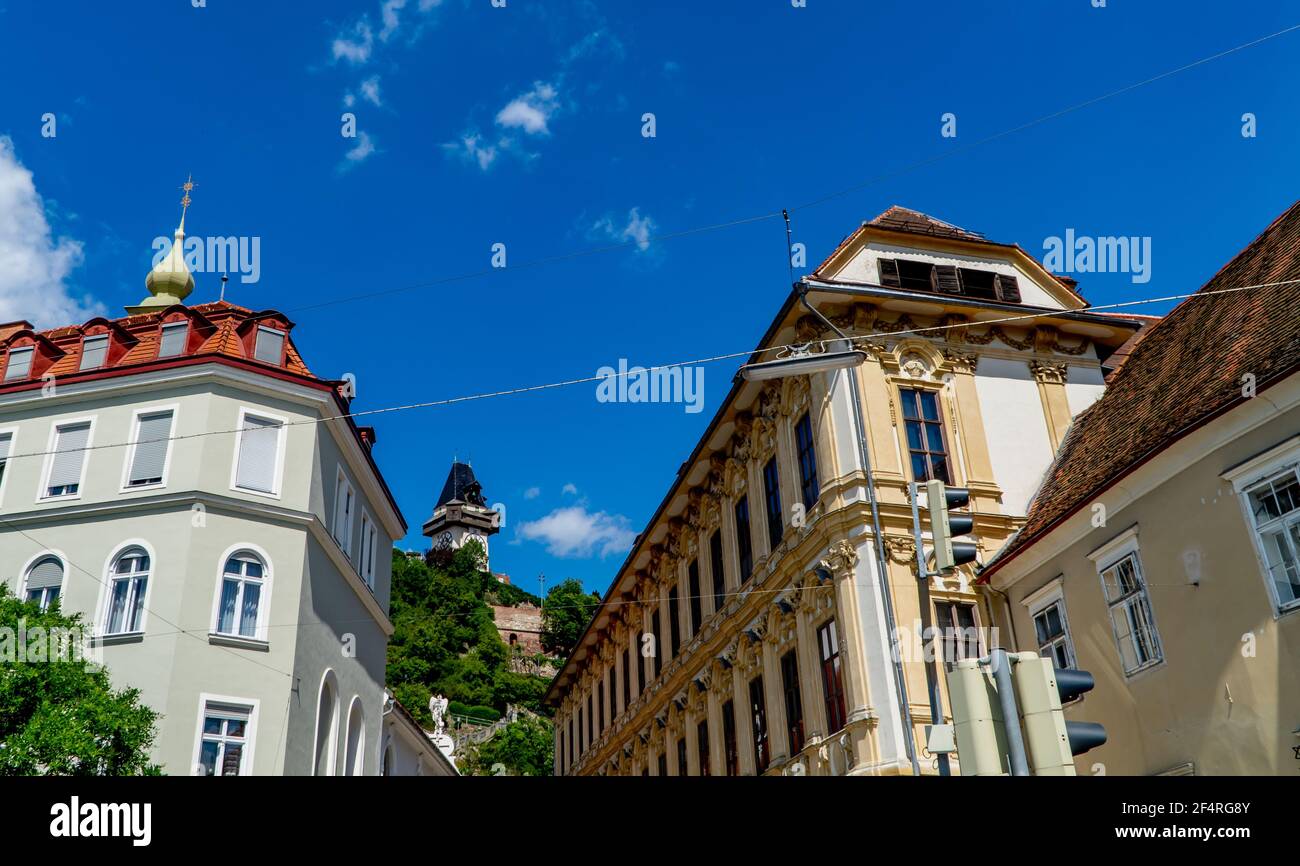 Traditional Austrian architecture in Graz with the Schlossberg (castle hill) in the background Stock Photo