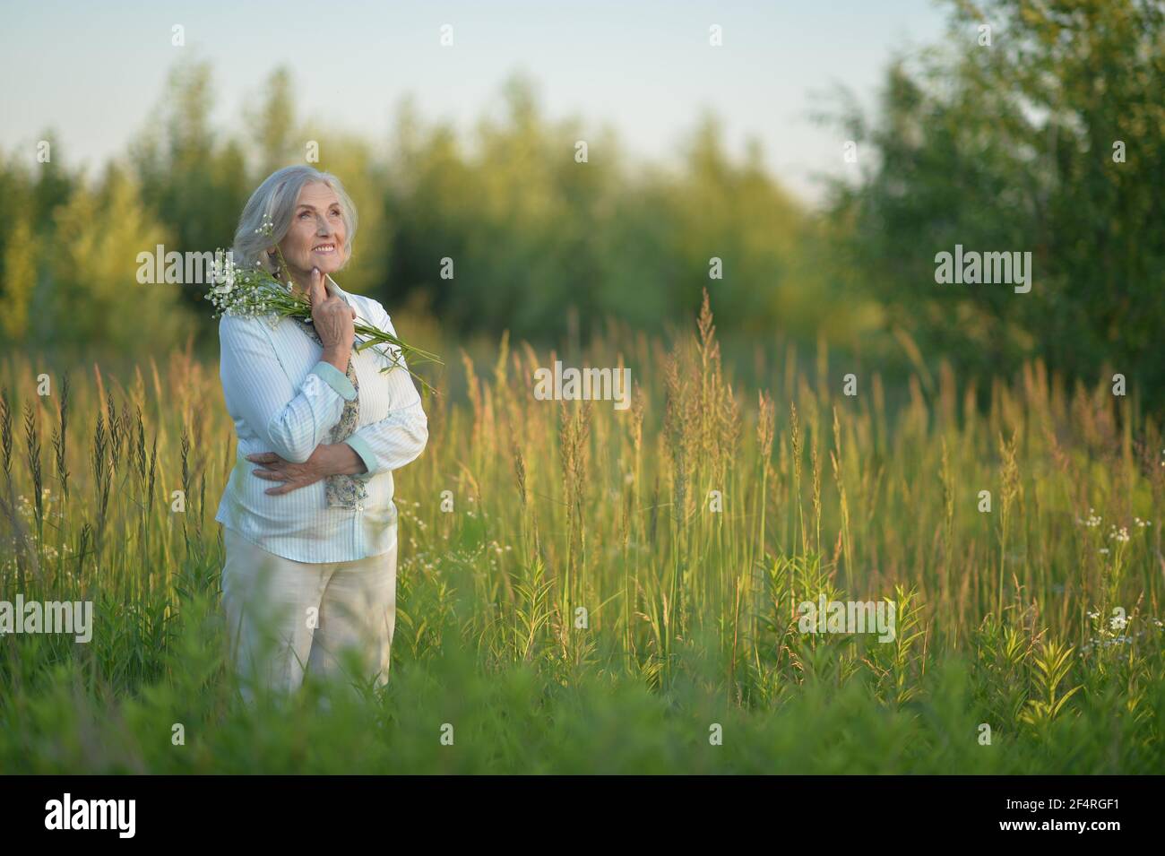 Mature woman field of flowers hi-res stock photography and images - Alamy