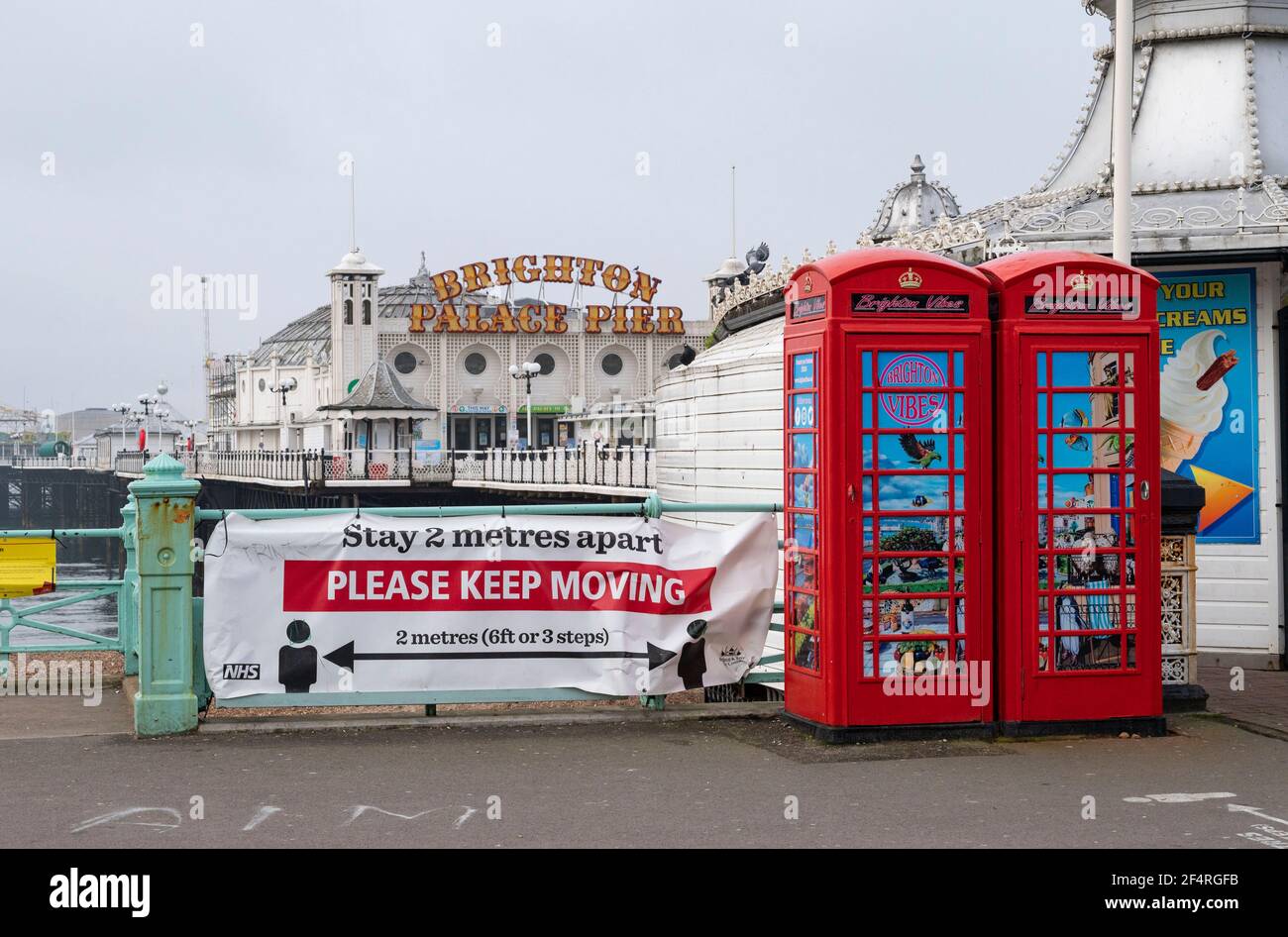 Brighton UK 23rd March 2021 - Brighton seafront by the pier on the first anniversary of the coronavirus COVID-19 lockdown in the UK as the country will mark a national day of reflection with a minutes silence at noon and candles being lit on doorsteps tonight :  Credit Simon Dack / Alamy Live News Stock Photo