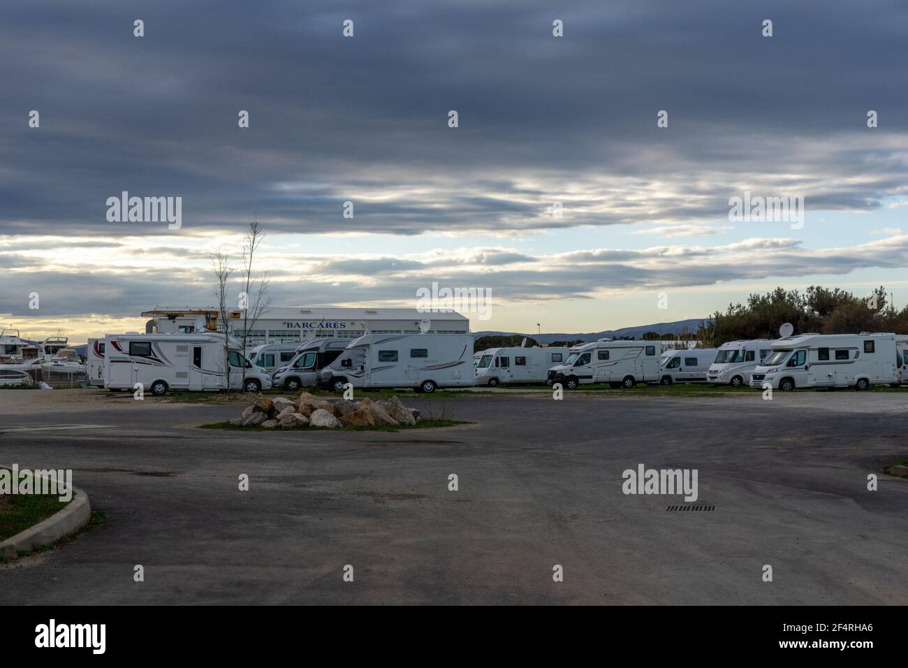 Le Barcares, France - 13 March, 2021: many camper vans and RVs parked in the RV Park in the harbor at Port Barcares under an overcast sky Stock Photo