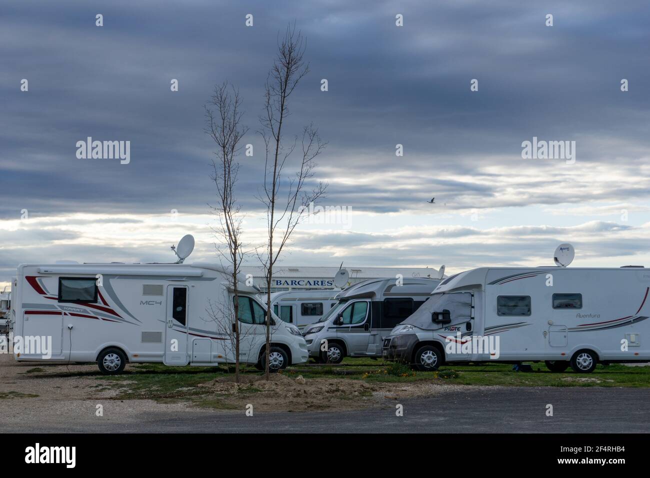 Le Barcares, France - 13 March, 2021: many camper vans and RVs parked in the RV Park in the harbor at Port Barcares under an overcast sky Stock Photo