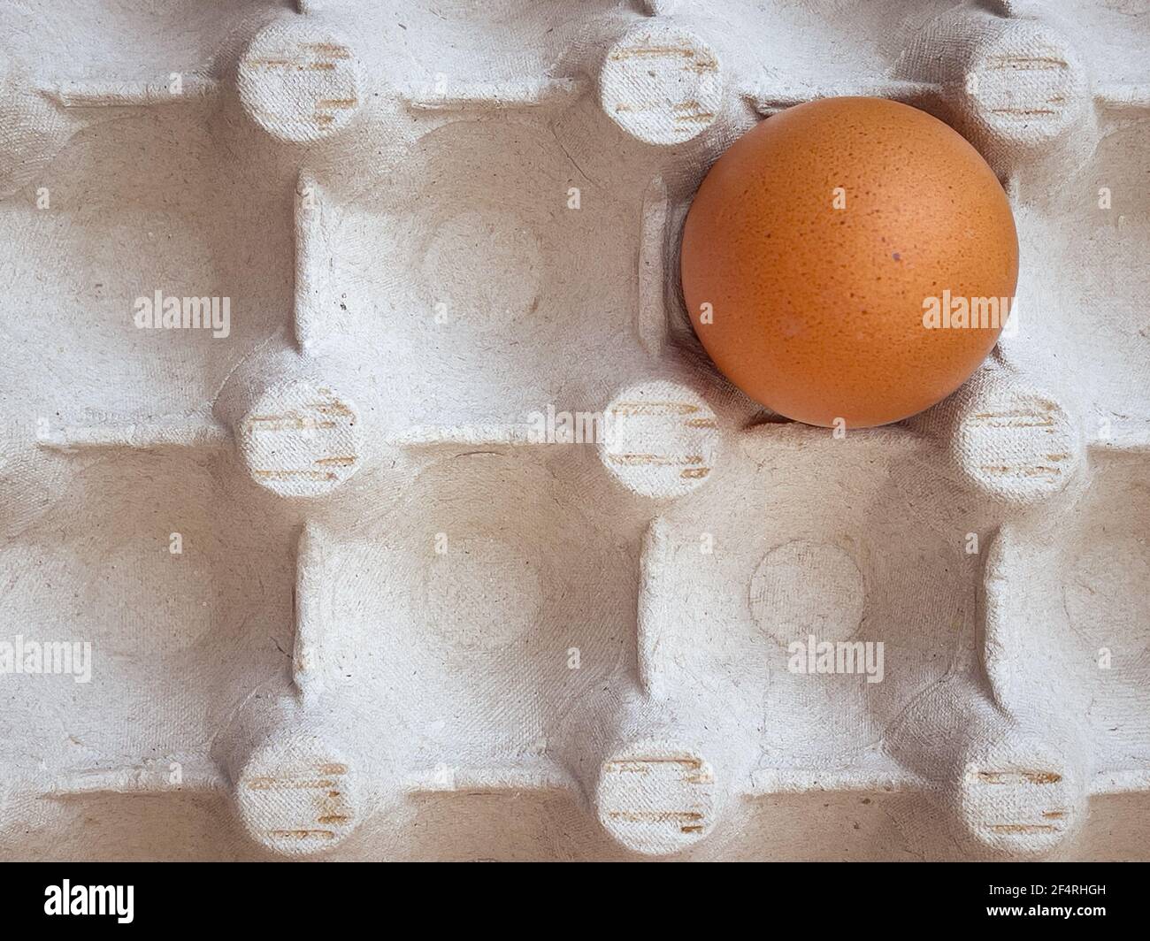 Brown eggs in cardboard egg box. Top view of raw organic chicken eggs in carton. Stock Photo