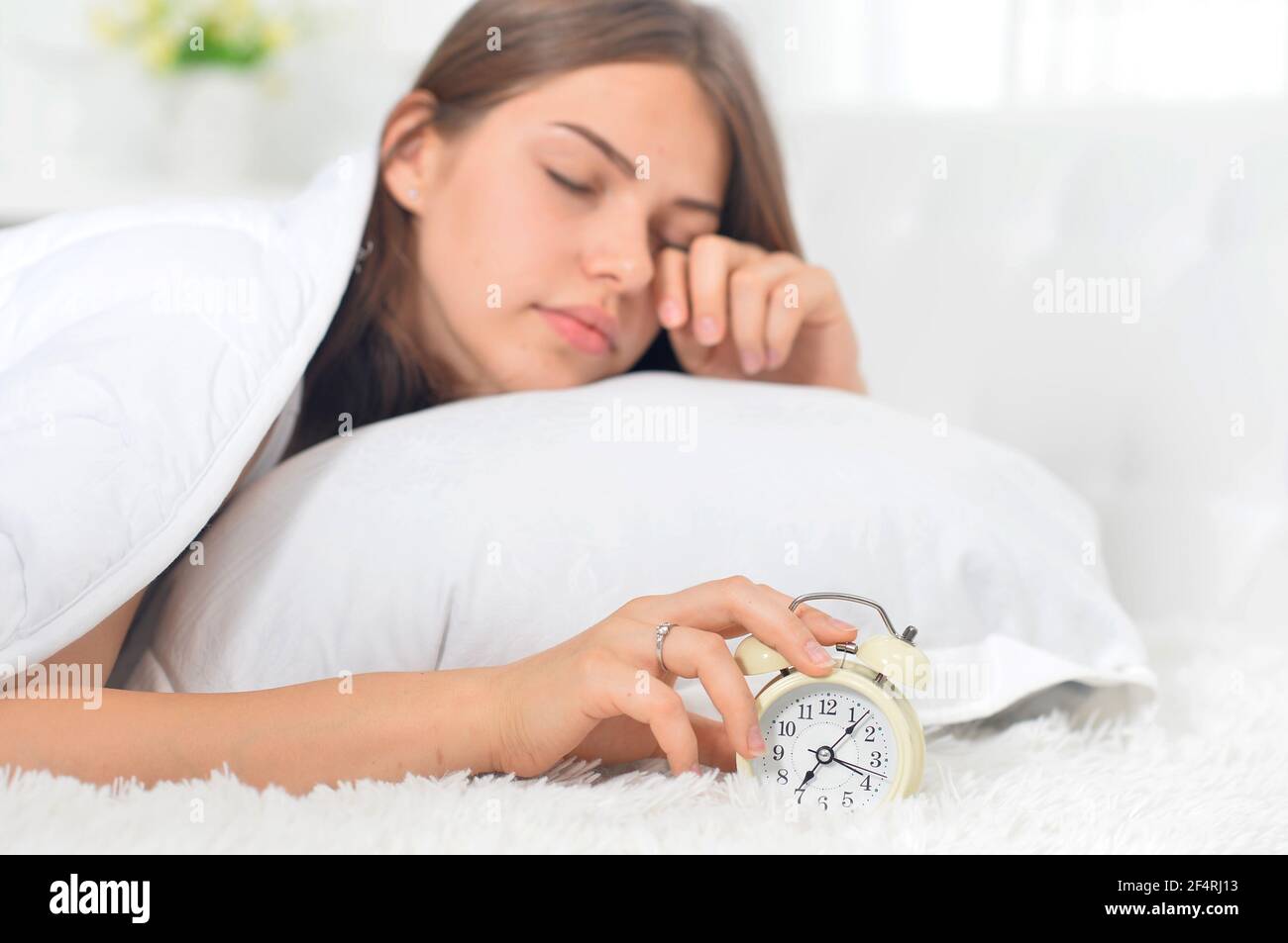 Beautiful young woman awaking on soft bed on morning Stock Photo - Alamy