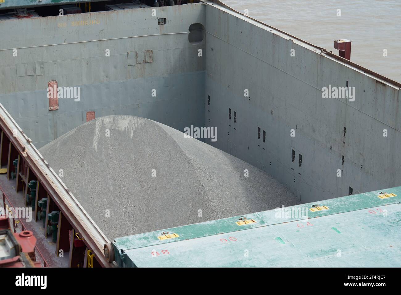 Cargo hold of bulk carrier ship full of bulk cargo bauxite Stock Photo