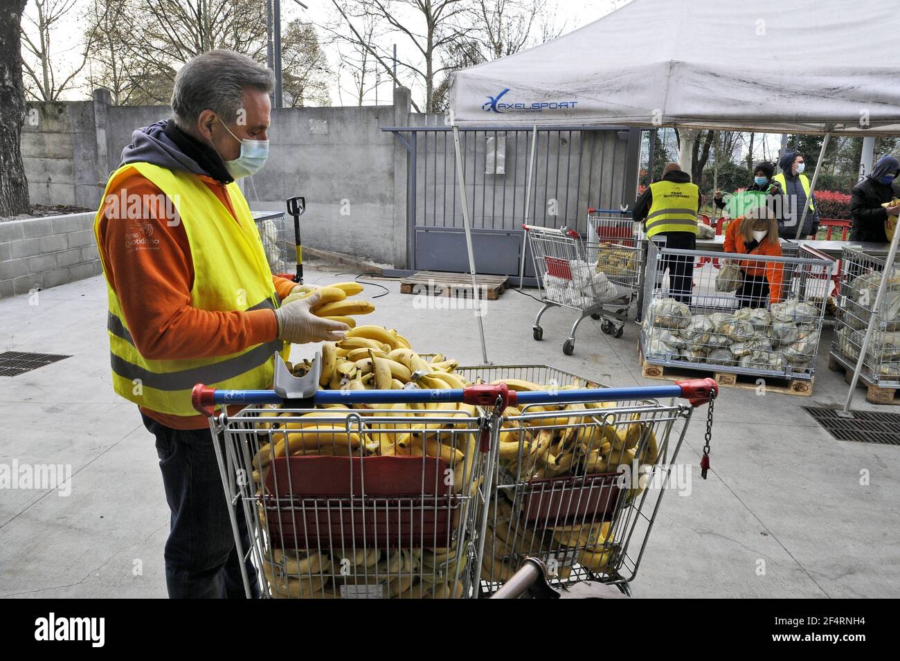 Milan (Italy), the non-profit organisation Pane Quotidiano (Daily Bread) distributes essential foodstuffs to people in economic difficulty due to the crisis caused by the Coronavirus epidemic. More and more social groups are affected, and every day the queue gets longer. Stock Photo