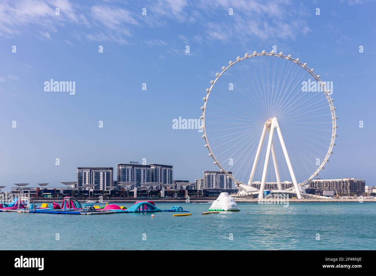 Dubai, UAE, 22.02.2021. Skyline of Bluewaters Island with Ain Dubai (Dubai Eye) tallest ferris wheel in the world and water bay with floating fun park Stock Photo