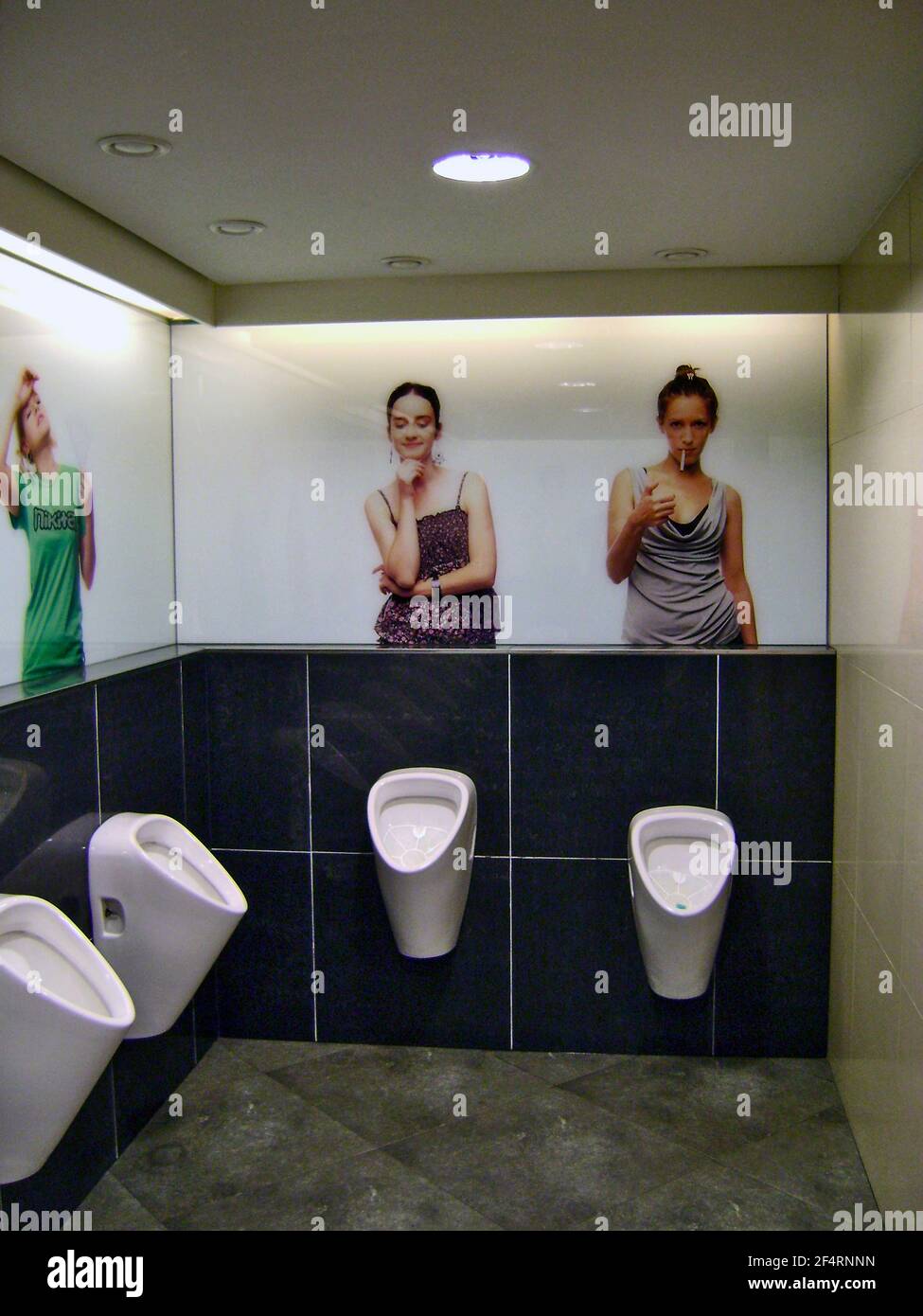 Praha, Czech Republic, April 28, 2010. Toilet in a restaurant with interesting photos on the wall. Stock Photo