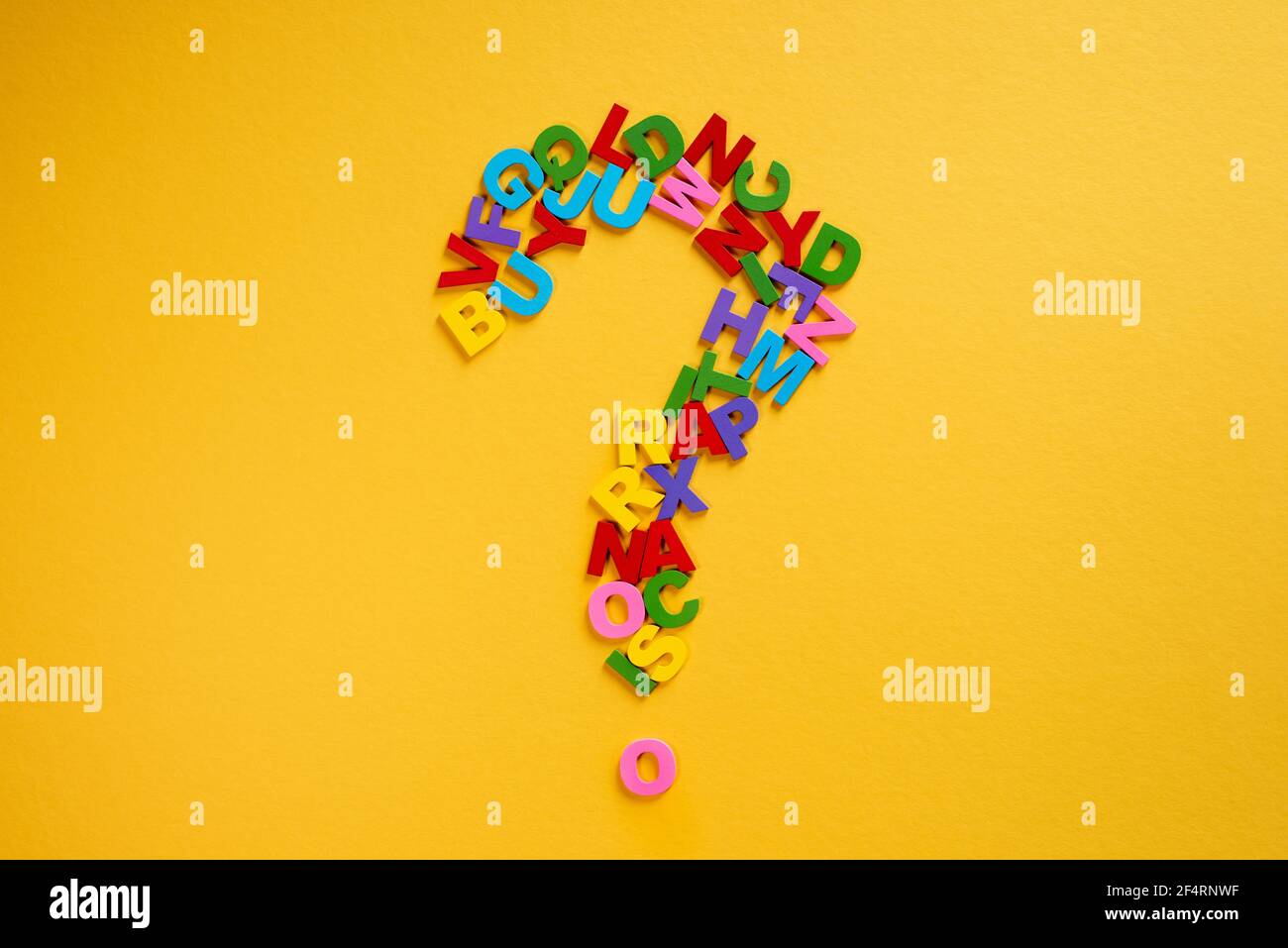 Alphabet forming a question mark on a yellow background Concept of ...