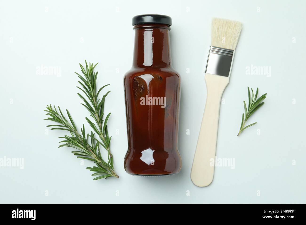 Barbecue sauce, rosemary and brush on white background Stock Photo Alamy