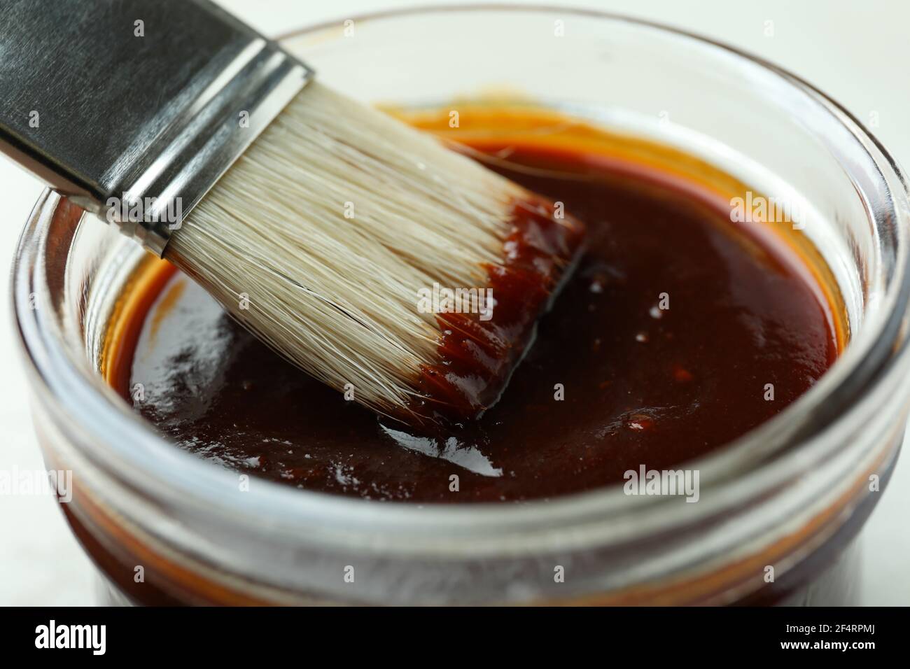 Jar of barbecue sauce with brush, close up Stock Photo Alamy