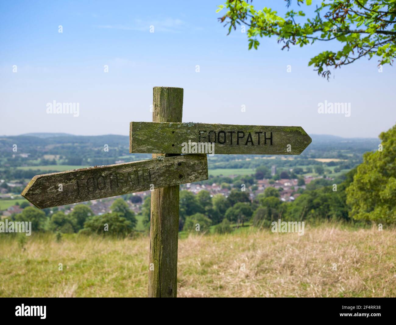 A wooden footpath sign on Old Hill overlooking the village of Wrington, North Somerset, England. Stock Photo