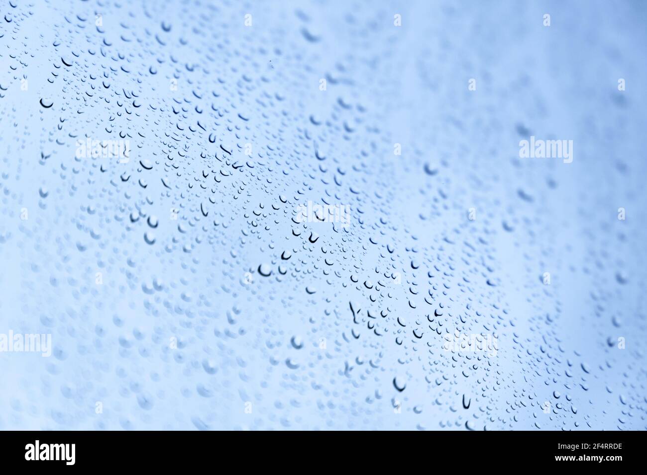 Water drops are on a glass under blue sky, background photo texture ...