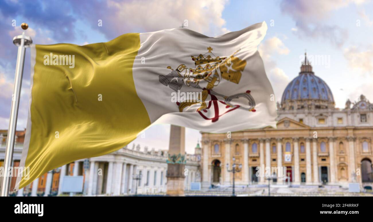 The flag of the Vatican city state fluttering in the wind with St. Peter's basilica blurred in the background. Travel and tourism. Catholicism and fai Stock Photo