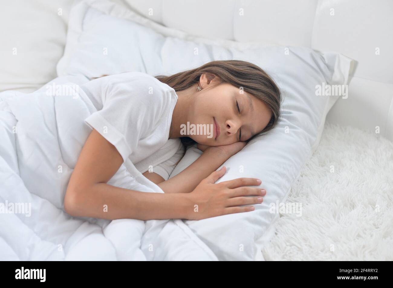 Cute little girl sleeping in bed at home Stock Photo Alamy