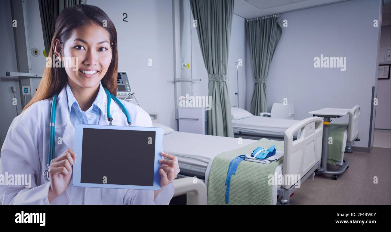 Portrait of caucasian female doctor holding digital tablet at hospital Stock Photo