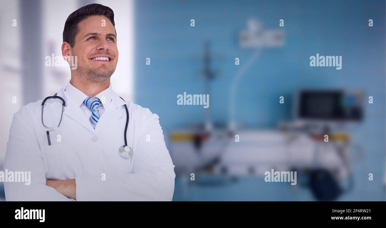 Portrait of caucasian male doctor wearing lab coat smiling at hospital