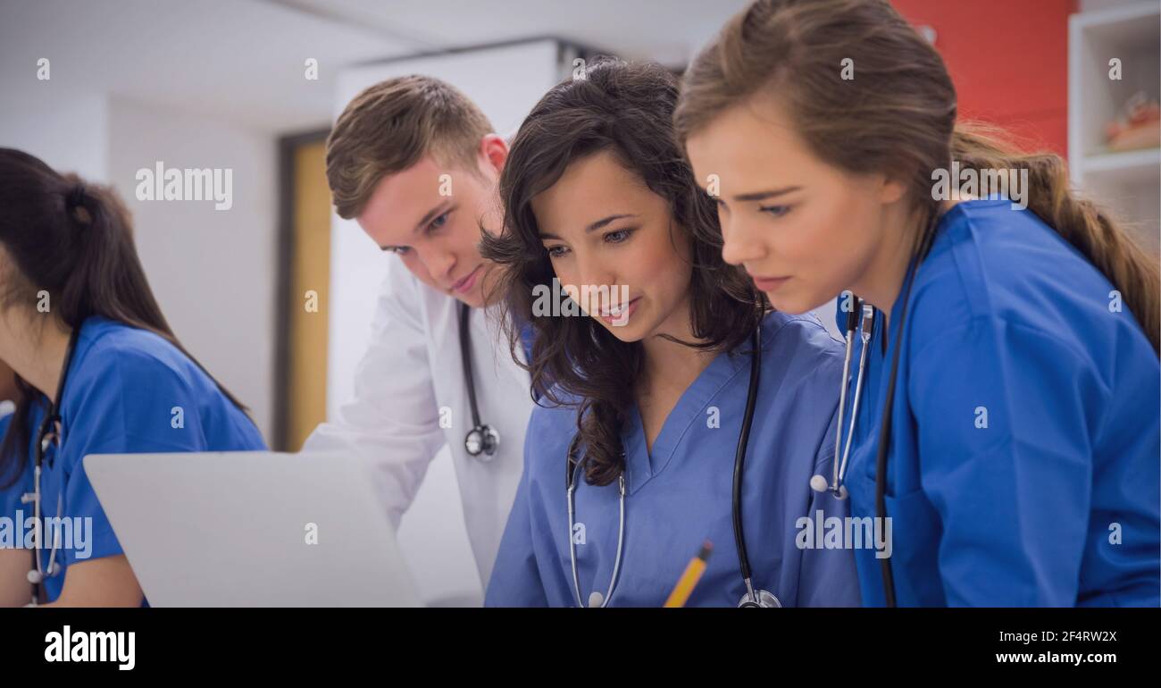 Team of caucasian male and female health workers working together at hospital Stock Photo