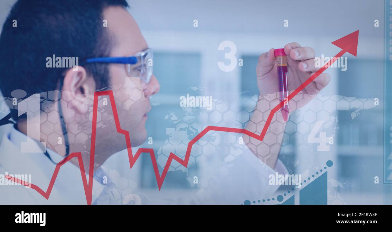 Financial data processing against male caucasian health worker working at laboratory Stock Photo