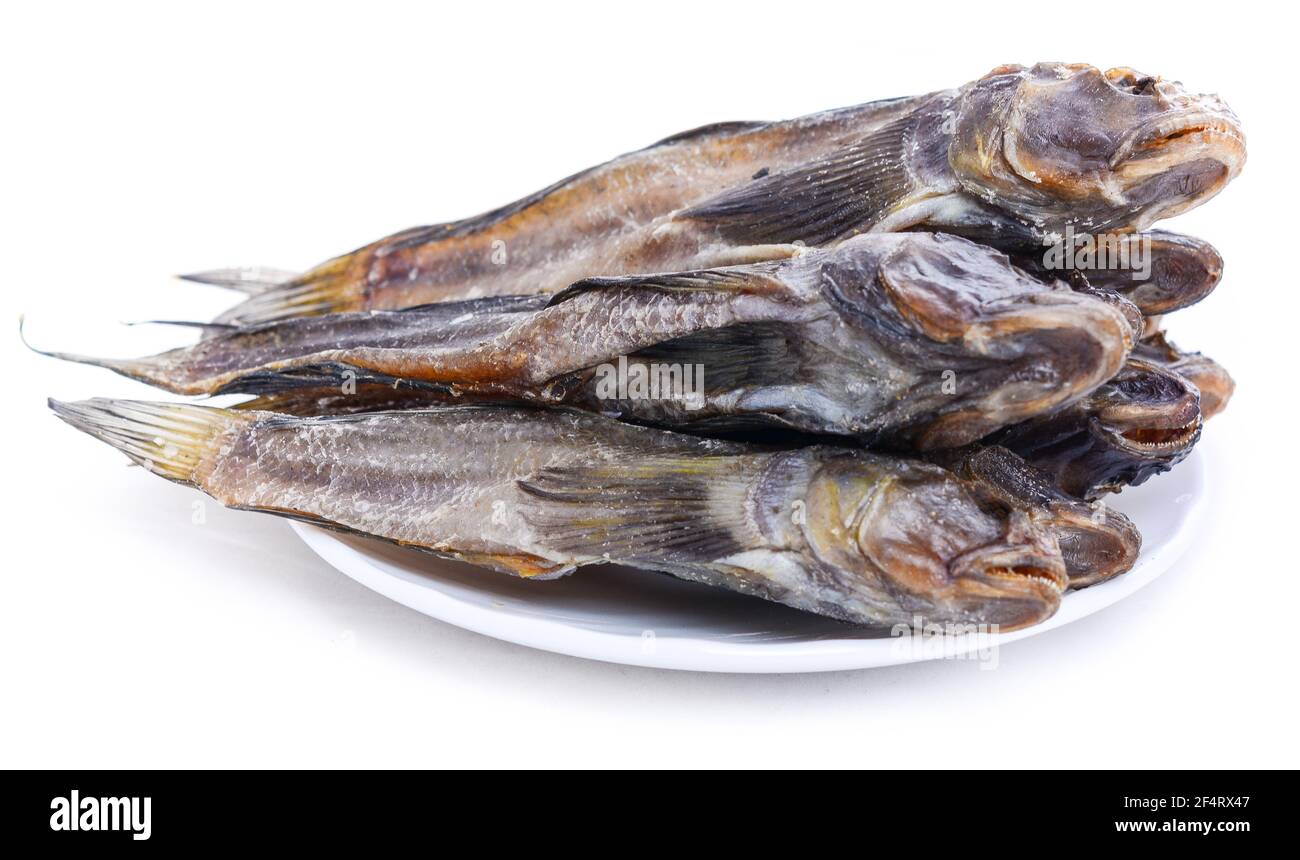 Group of dried fish at plate . Seafood in salt Stock Photo