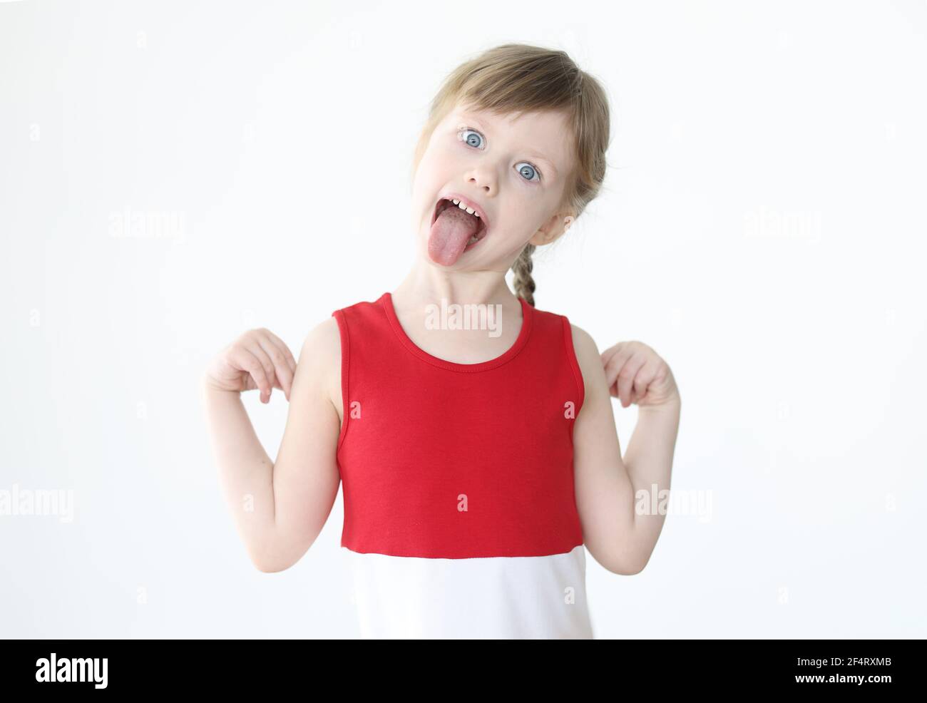 Little girl in red dress showing tongue Stock Photo - Alamy, image size:1300x986