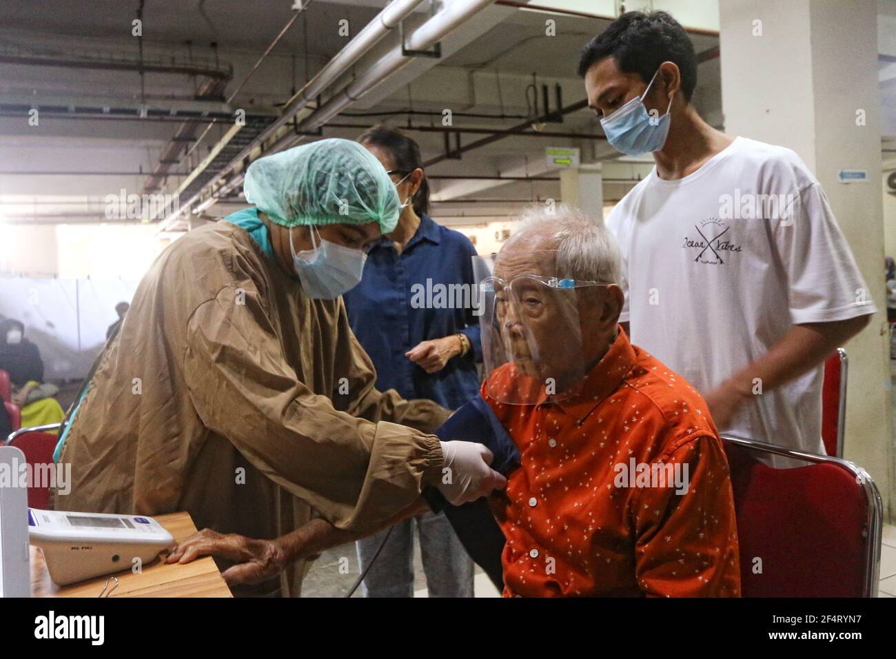 104 year old man, Wirjawan Hardjamulia following a Covid-19 vaccination injection at a hospital in Bogor on March 23, 2021 Stock Photo
