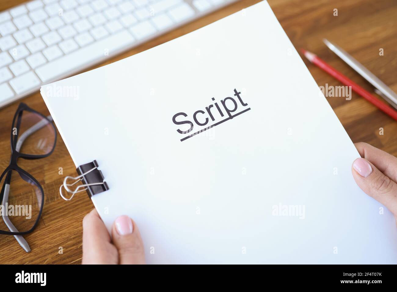 Female hands holding script over table closeup Stock Photo