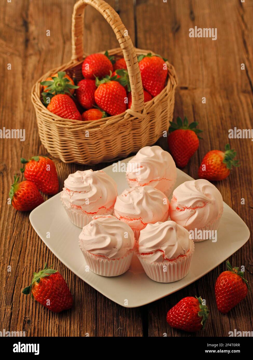 Meringues with strawberries. Stock Photo