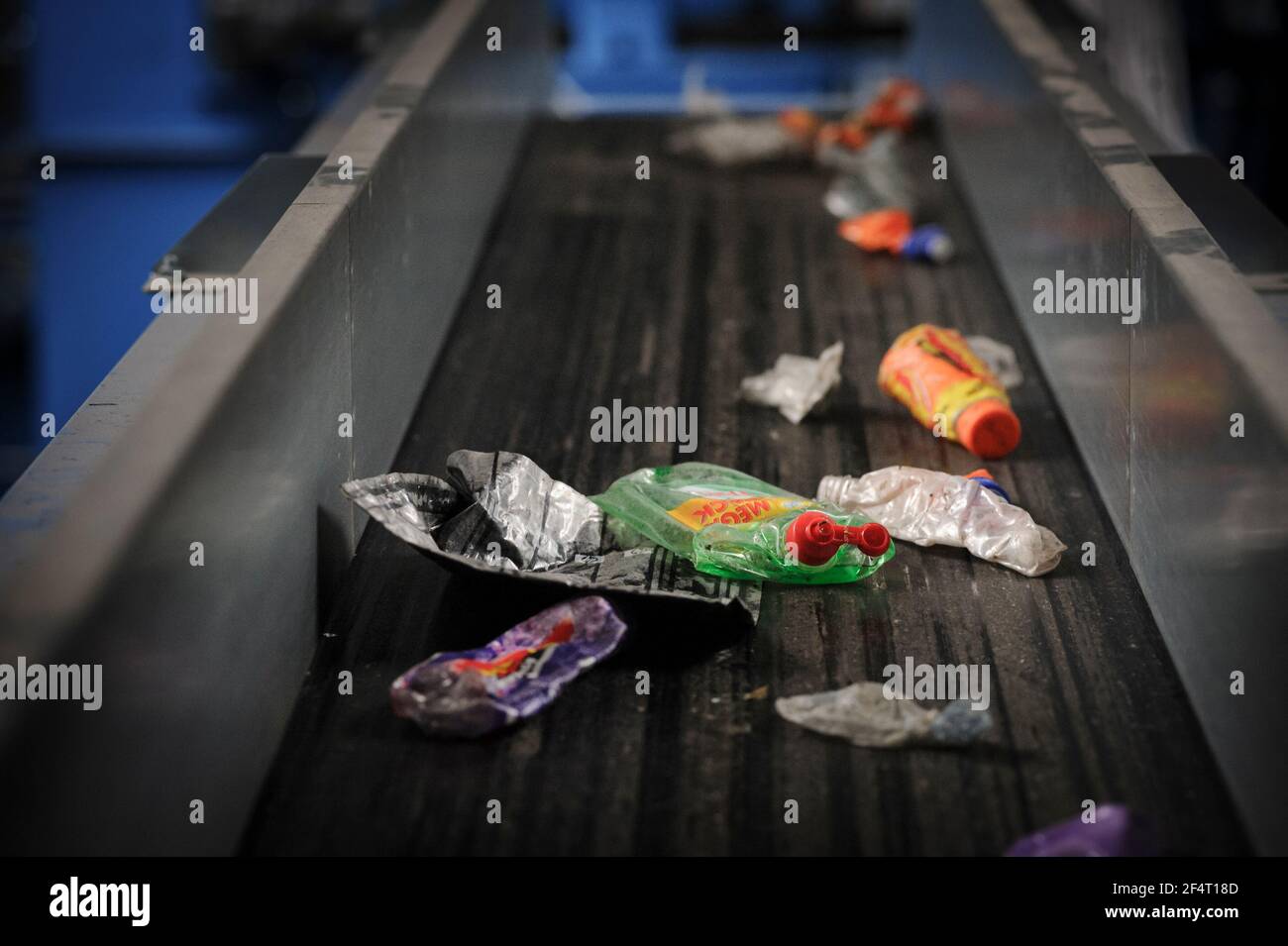 Plastic waste on a conveyor belt for sorting at a materials recycling facility in the UK. Stock Photo