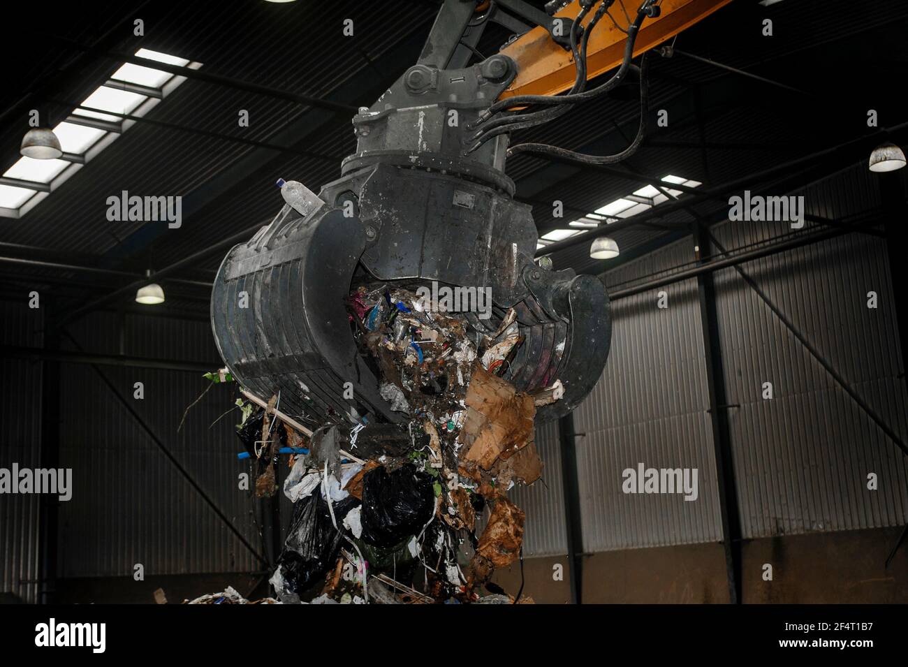 Mechanical grabber at work in a recycling plant in England. Stock Photo