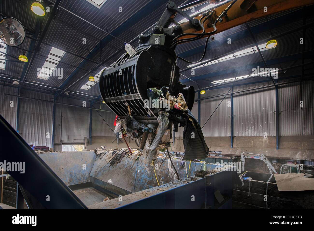 Mechanical grabber at work in a recycling plant in England. Stock Photo