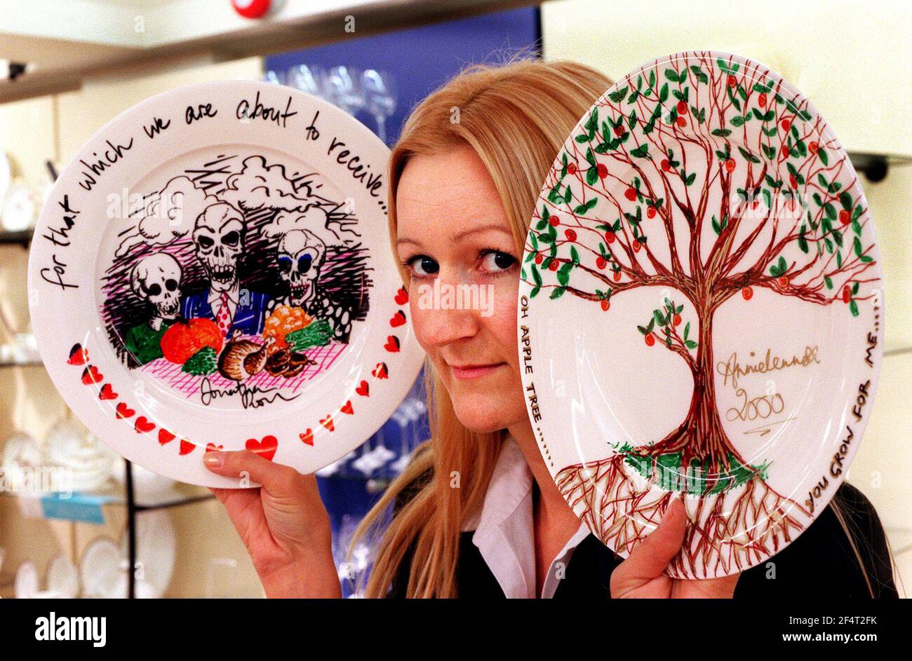 THE VARIETY CLUB HAS ASKED CELEBRITIES TO DESIGN A DINNER PLATE FOR AN ON-LINE AUCTION TO START ON NOVEMBER 20TH.SOME OF THE PLATES WERE ON DISPLAY IN REGENT STREET, AND THE PICTURE SHOWS SHOP MANAGER FIONA FLINDALL WITH TWO OF THE PLATES DESIGNED BY( LEFT) JONATHAN ROSS AND (RIGHT) ANNIE LENNOX. Stock Photo