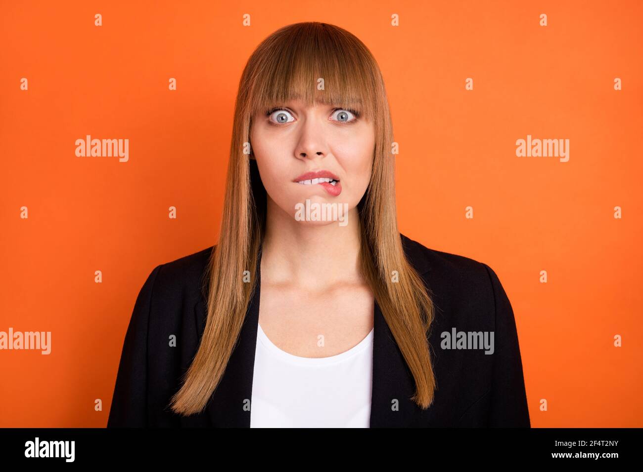 Photo of sad nice blond hair lady bite lip wear black jacket isolated on bright orange color