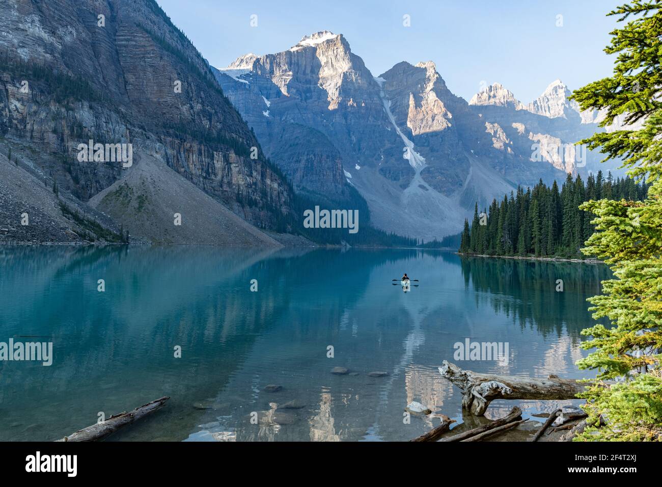 single canoeist on a tranquil Moraine Lake in the Rocky Mountains Stock Photo