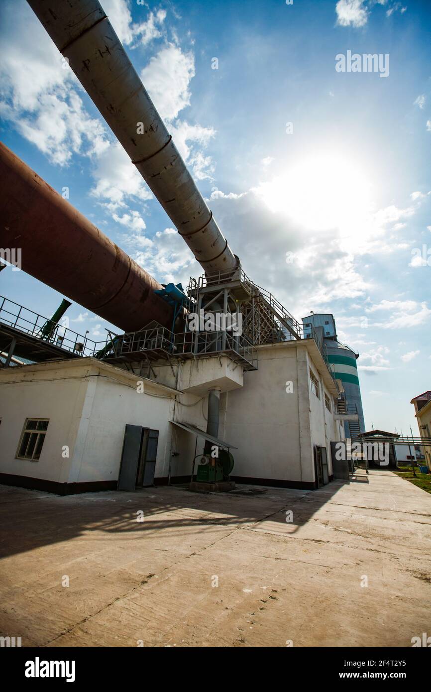 Standard Cement plant. Rotary clinker kiln, industrial building and