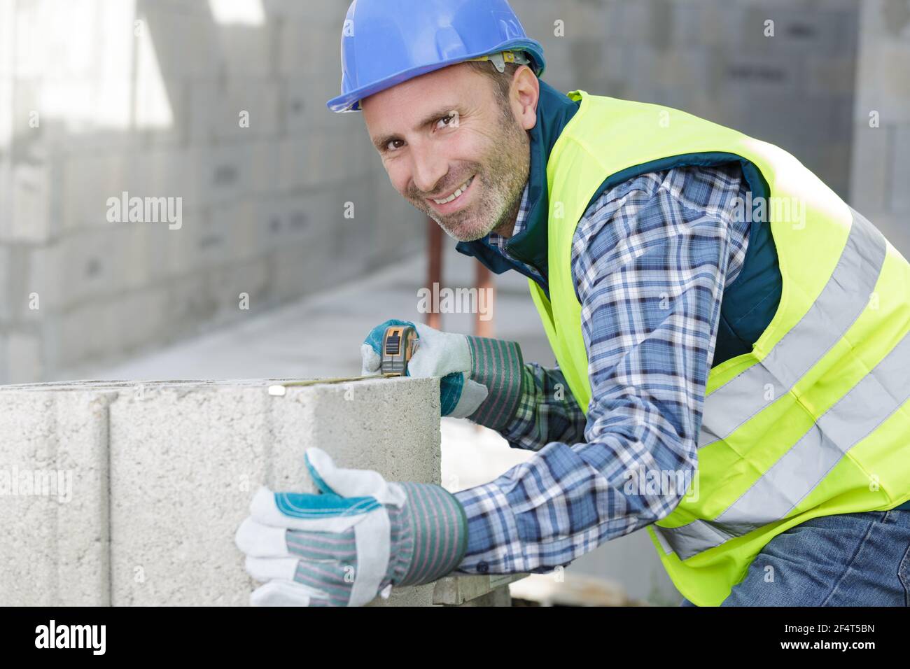 bricklayer builder working with autoclaved aerated concrete blocks Stock Photo
