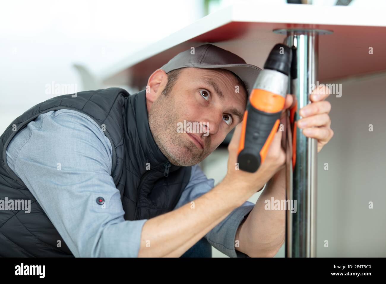 handyman using cordless drill for kitchen installation Stock Photo Alamy