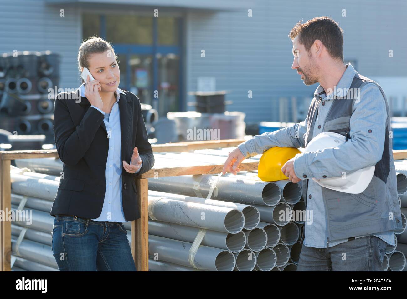construction manager and worker checking pipes quality Stock Photo