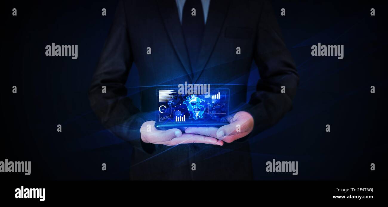 Modern cryptocurrency glowing holographic screen with bitcoin backdrop on mobile screen. Man holding mobile with glowing screen of cryptocurrency Stock Photo