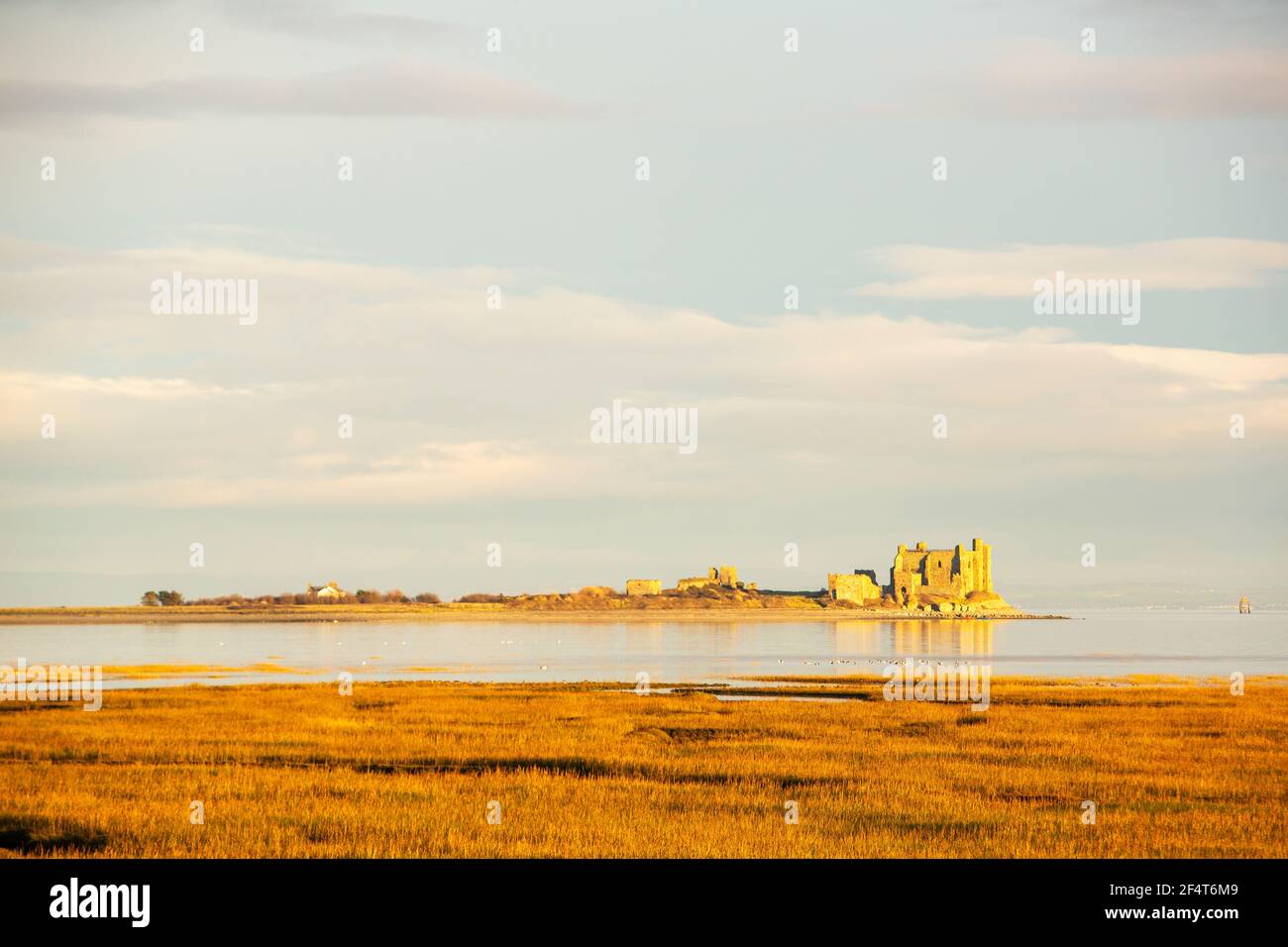 Looking across to Piel Island from Walney, Cumbria, UK, at sunset. Stock Photo