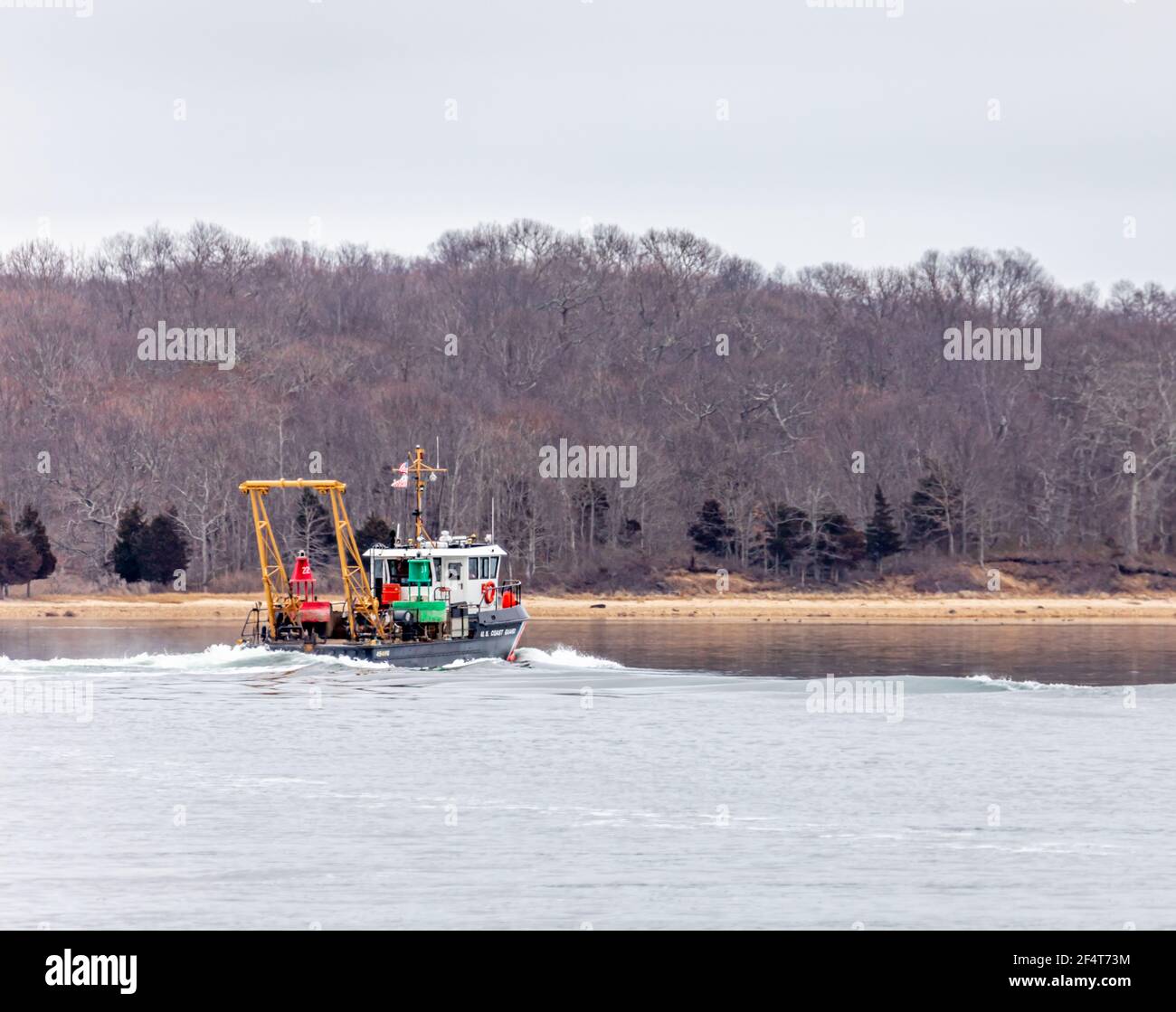 Coast Guard boat with setting navigational markers Stock Photo