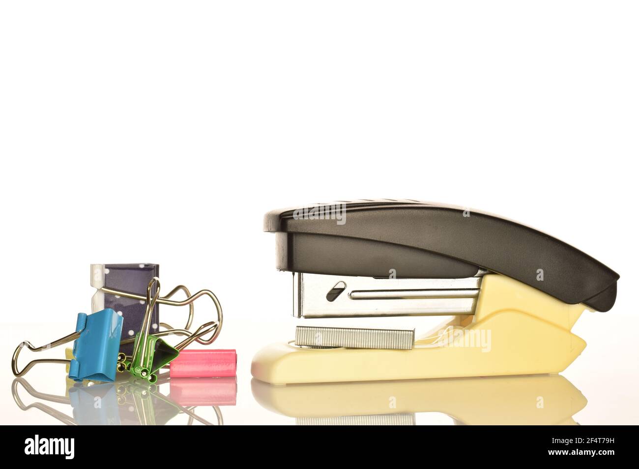One stationery stapler and several binders on a white background. Stock Photo