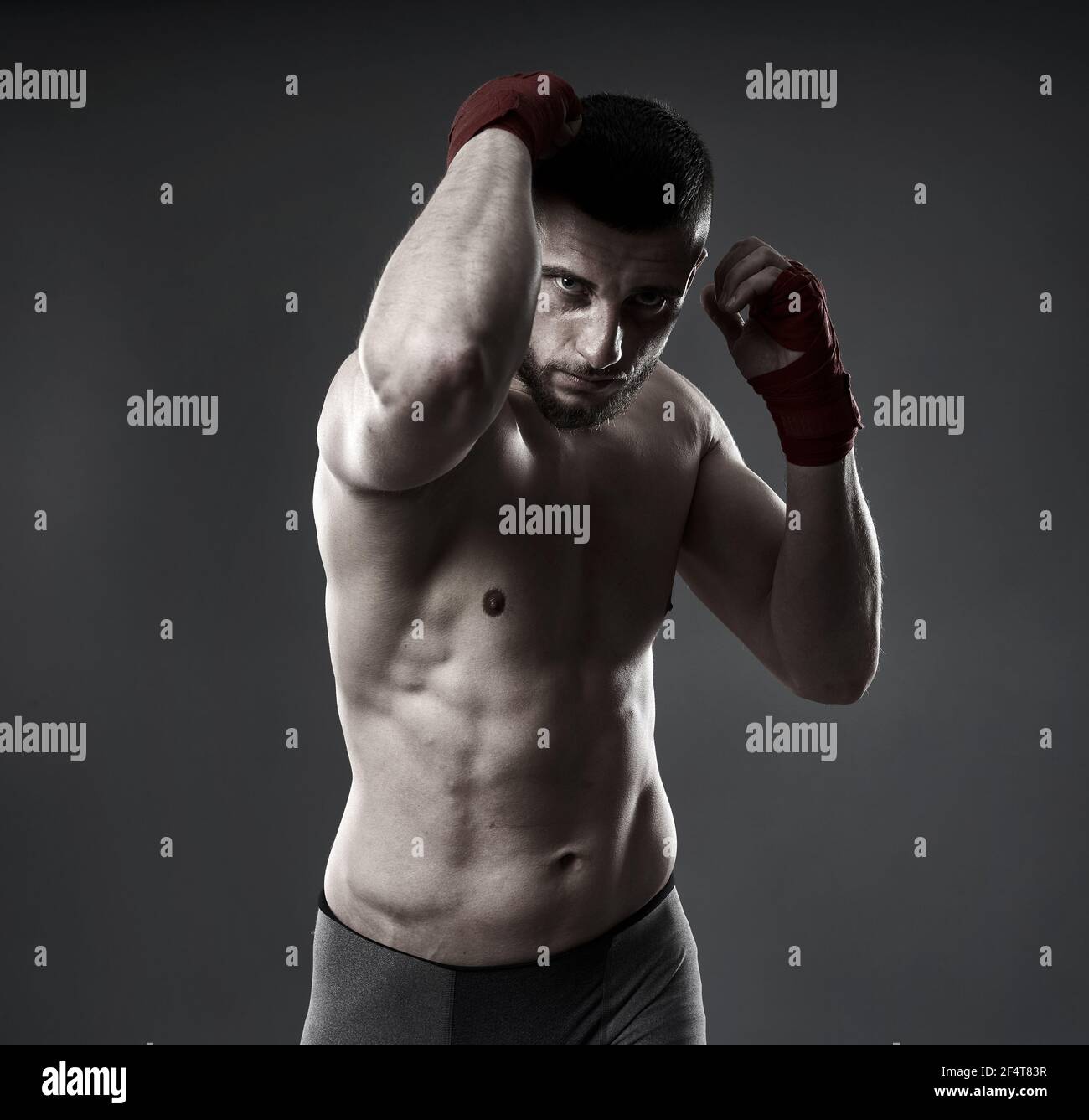 MMA fighter training, throwing an elbow strike, isolated on gray