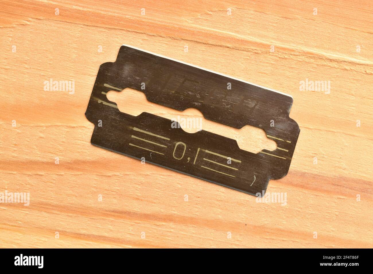 Shaving blade, macro, on a wooden table. Stock Photo