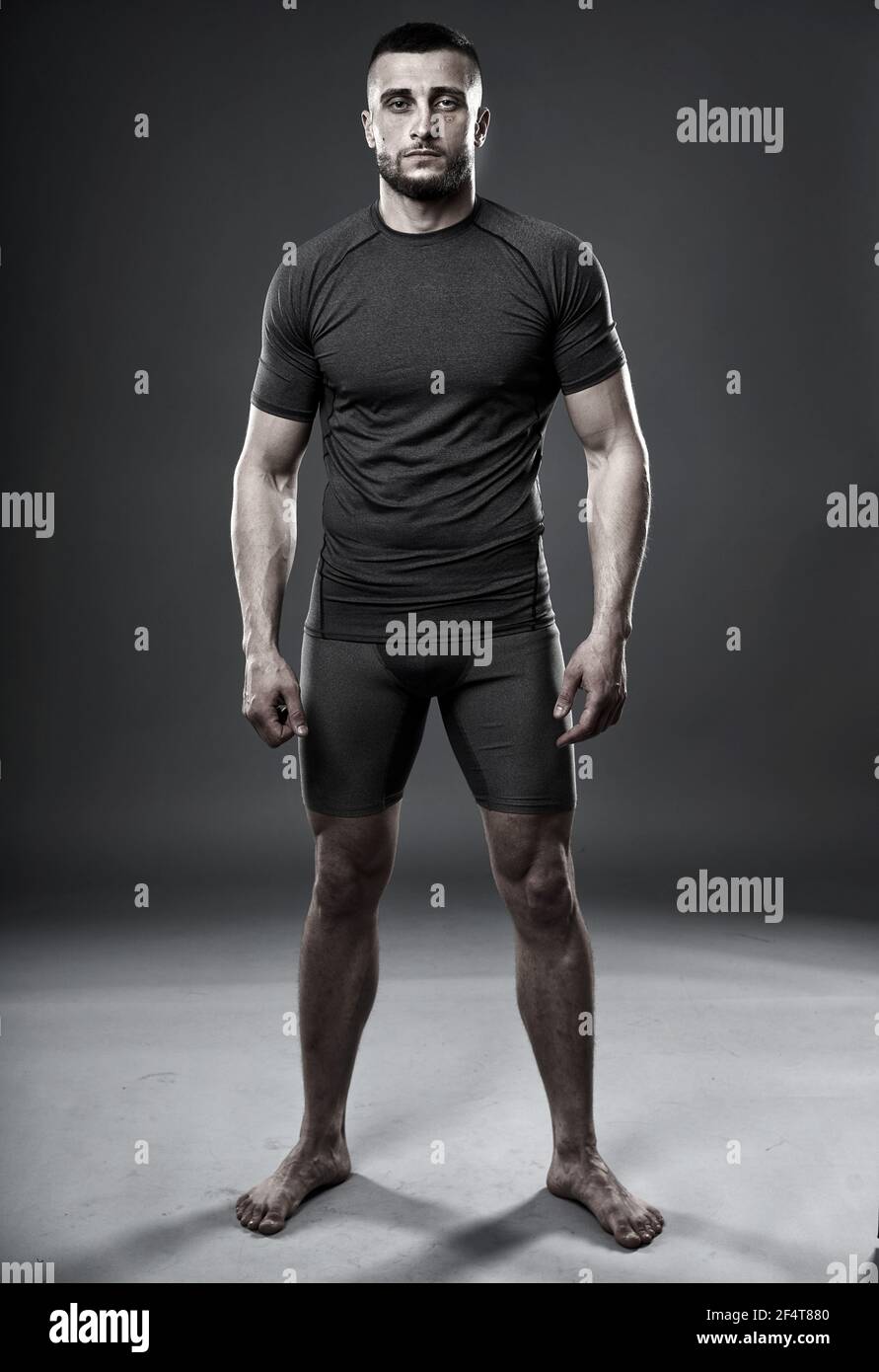 MMA fighter in training, posing for a shot oni gray background Stock Photo