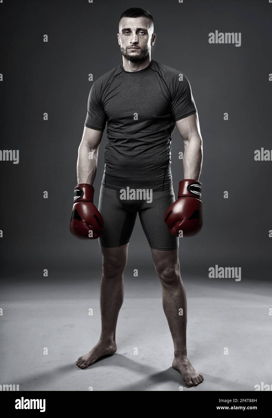 MMA fighter in training, posing for a shot oni gray background Stock Photo