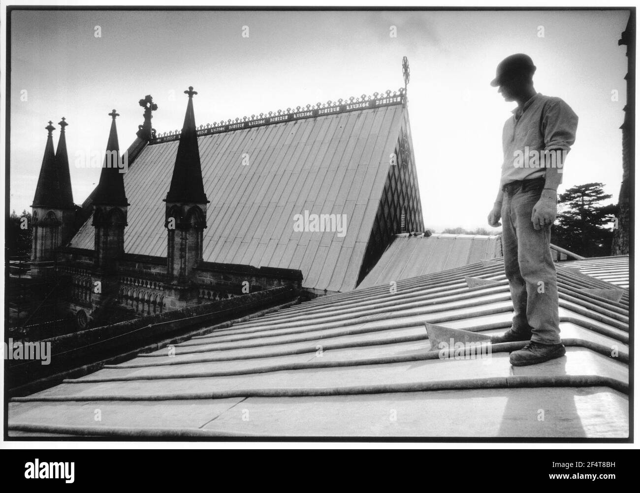 Stonemason Simon Hudson surveys the Lady Chapel April 2001 from the roof of the Hereford Cathedral. Stock Photo