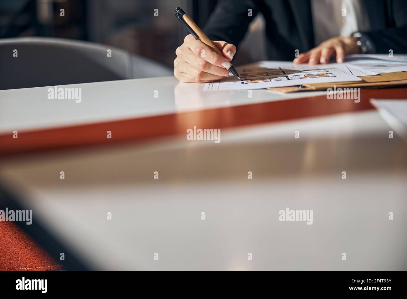 Engineer making corrections to a floor plan with a ball-point pen Stock Photo