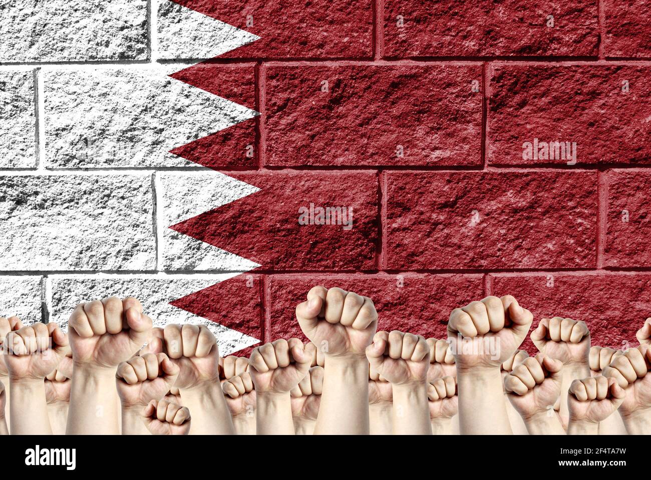 Raised fists against the background of the depicted flag of Bahrain on ...